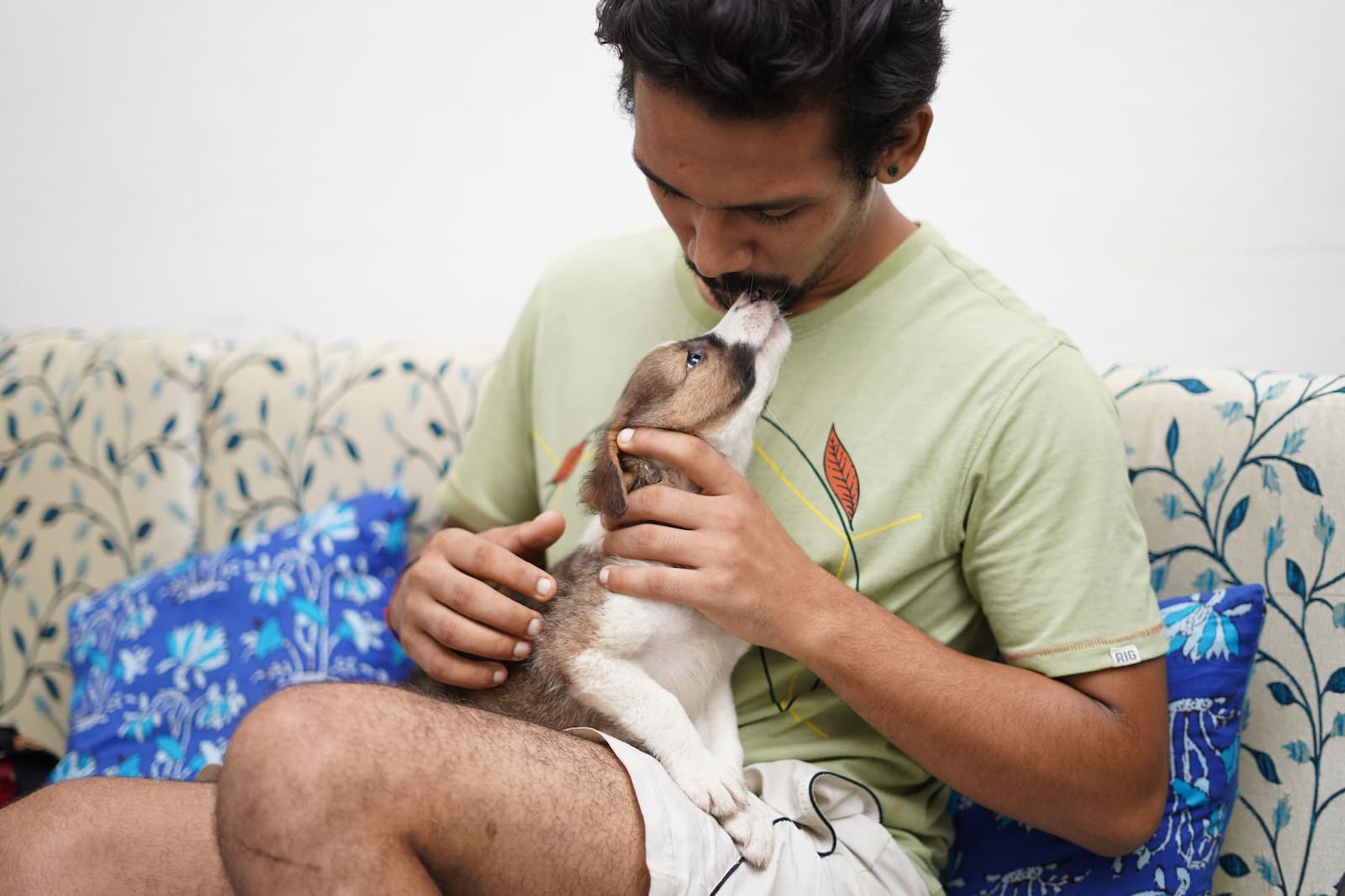 A new owner bonding with their puppy at home